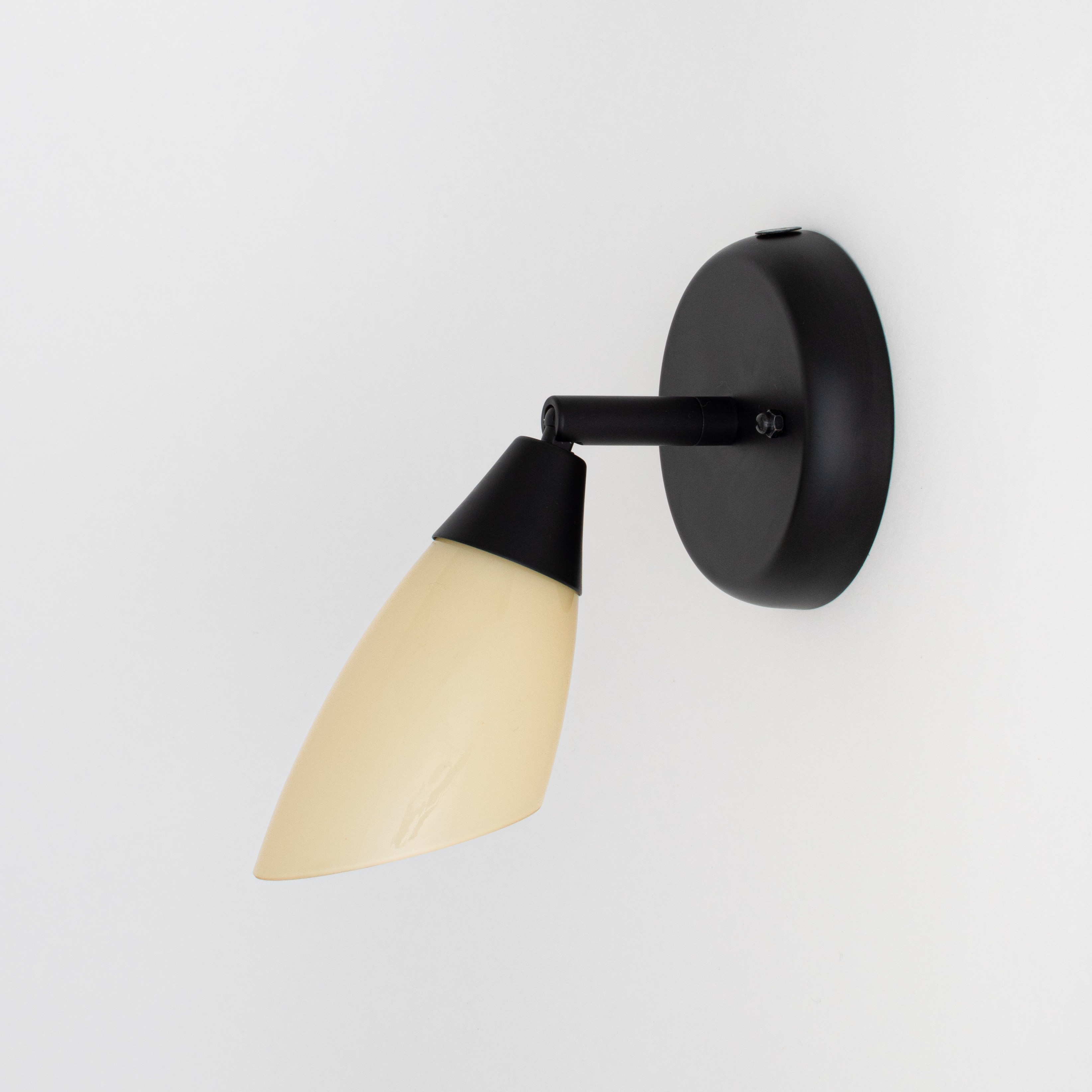 Spot mural noir avec charnière et abat-jour en verre jaune doux